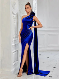 Thumbnail for Woman wearing a blue satin one-shoulder gown with a high slit in a white room.