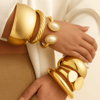 Thumbnail for Gold bracelets with pearl-like stones on a neutral background