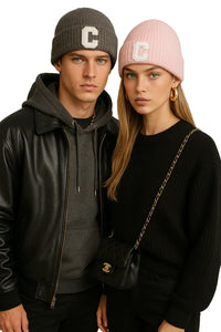 Thumbnail for Two people wearing matching beanies with a 'C' logo, standing close together.
