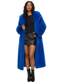 Thumbnail for Woman wearing a long blue fur coat, black top, and leather skirt on a white background