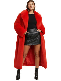 Thumbnail for Woman wearing a long red fur coat over a black top and leather skirt on a white background