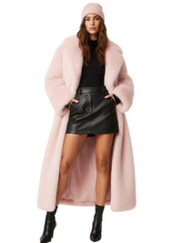 Thumbnail for Woman wearing a long light pink fur coat, black leather skirt, and black boots on a white background
