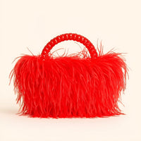 Thumbnail for Red ostrich feather handbag with a textured handle on a beige background