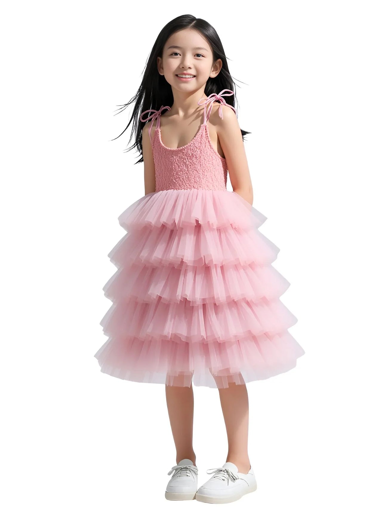 Young girl wearing a pink dress with a white background