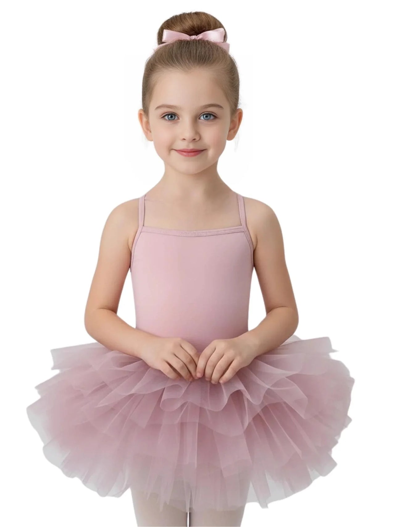 Young girl wearing a pink ballet tutu dress with thin straps on a white background