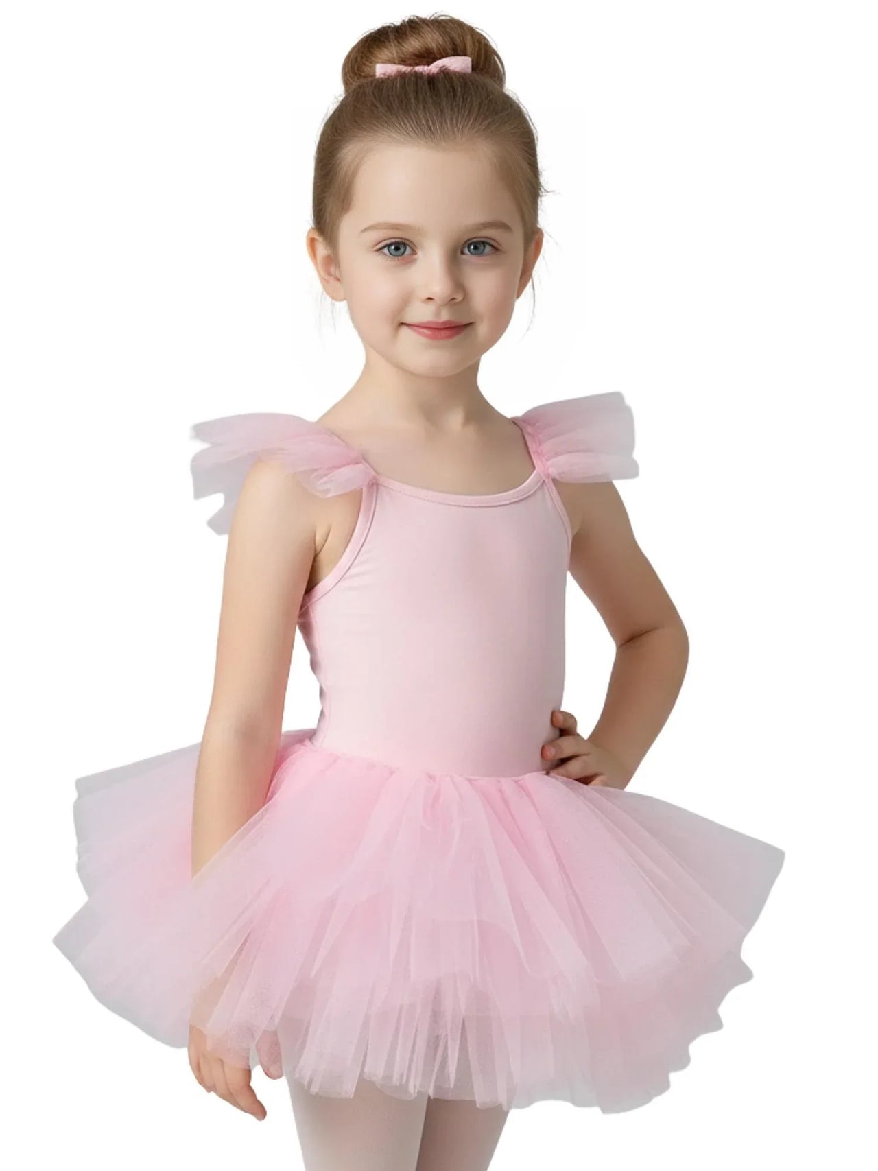 Young girl in a pink ballet tutu dress with pom pom straps on a white background