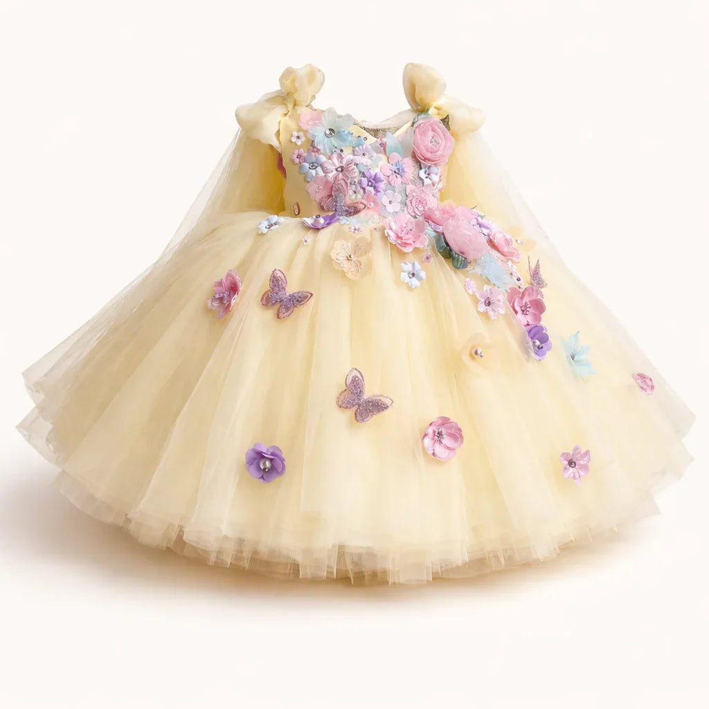 Yellow children's dress with floral and butterfly decorations on a white background