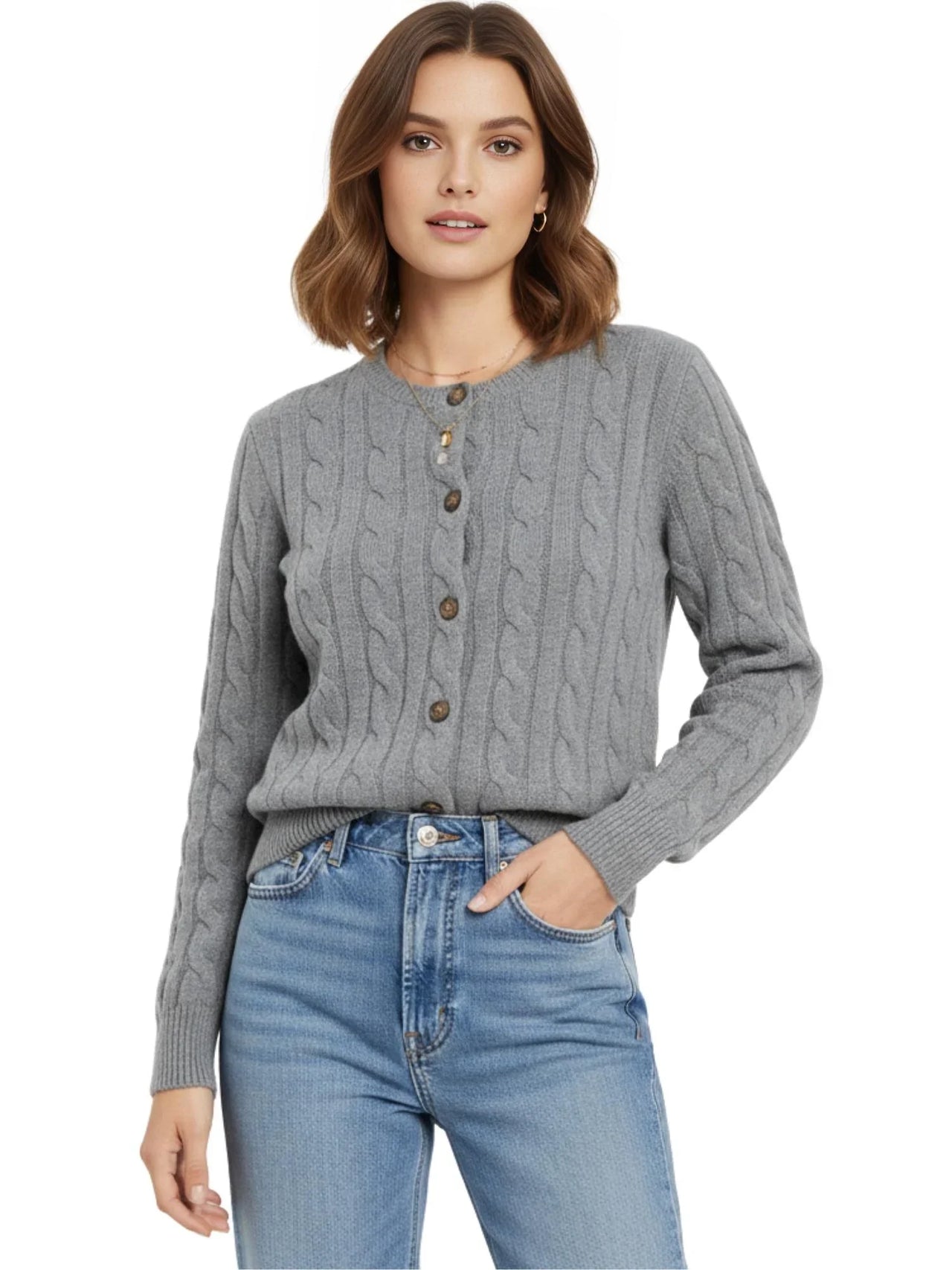 Woman wearing a grey cable knit sweater and blue jeans on a white background