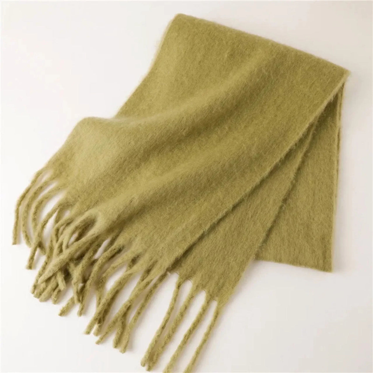 Green scarf with fringes on a white background