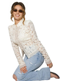 Thumbnail for Woman wearing a white lace blouse and blue jeans on a white background