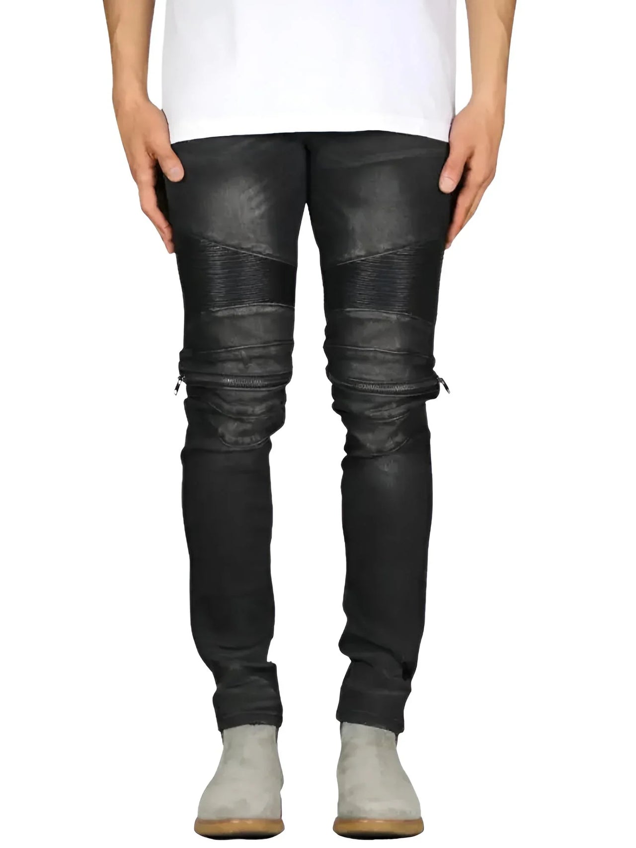 Person wearing black denim and leather jeans on a white background