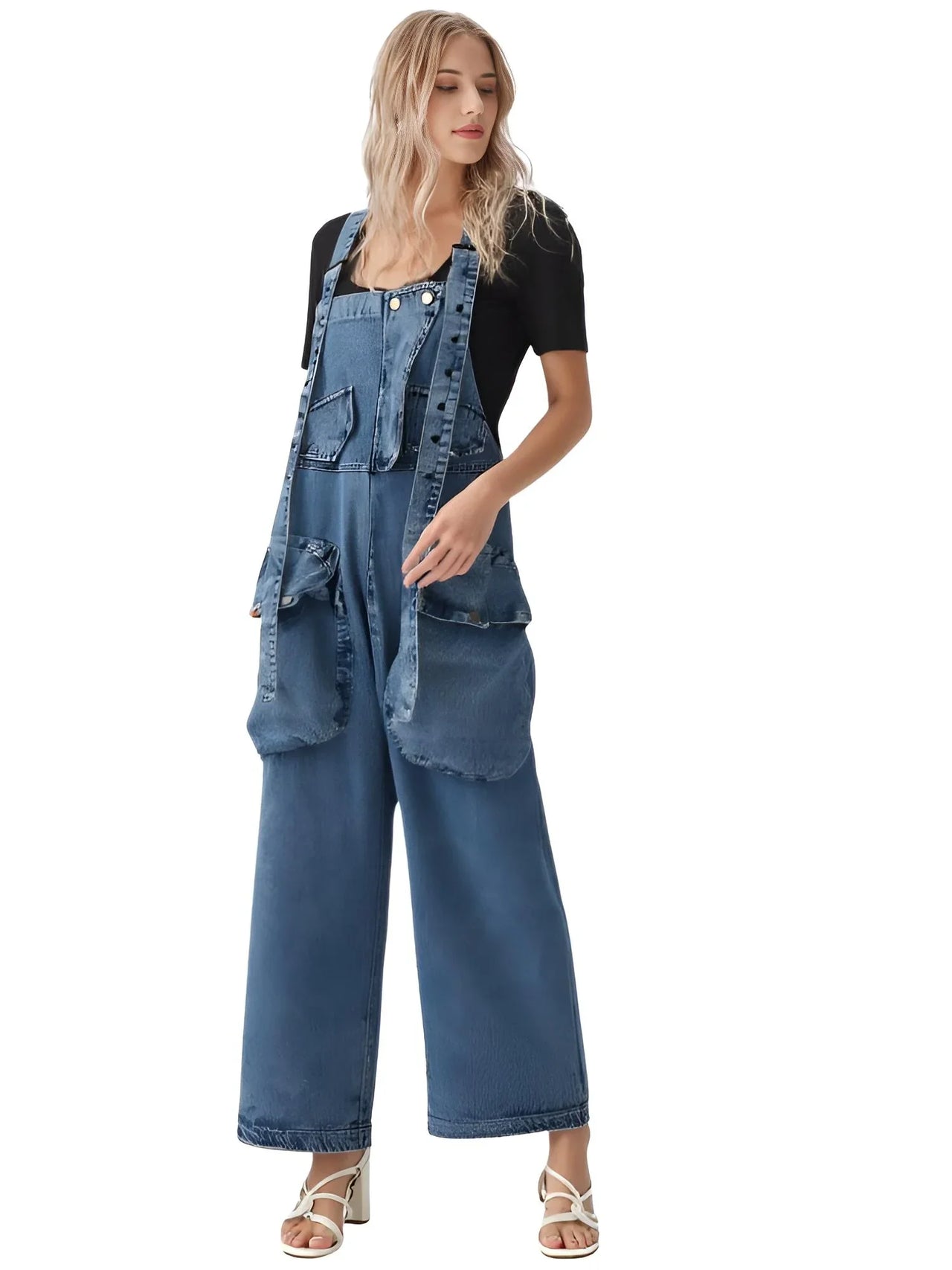 Woman wearing a blue denim overalls outfit on a white background