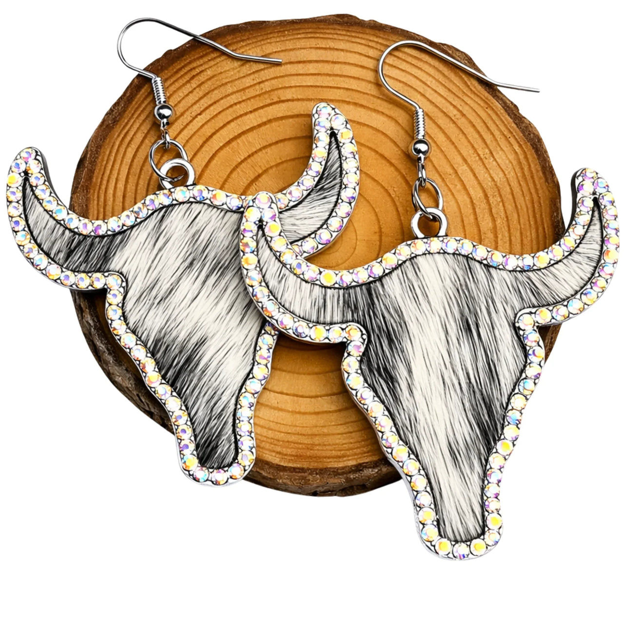 Longhorn steer earrings with rhinestone accents on a wooden background