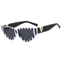 Thumbnail for Sunglasses with black and white striped frame on a white background