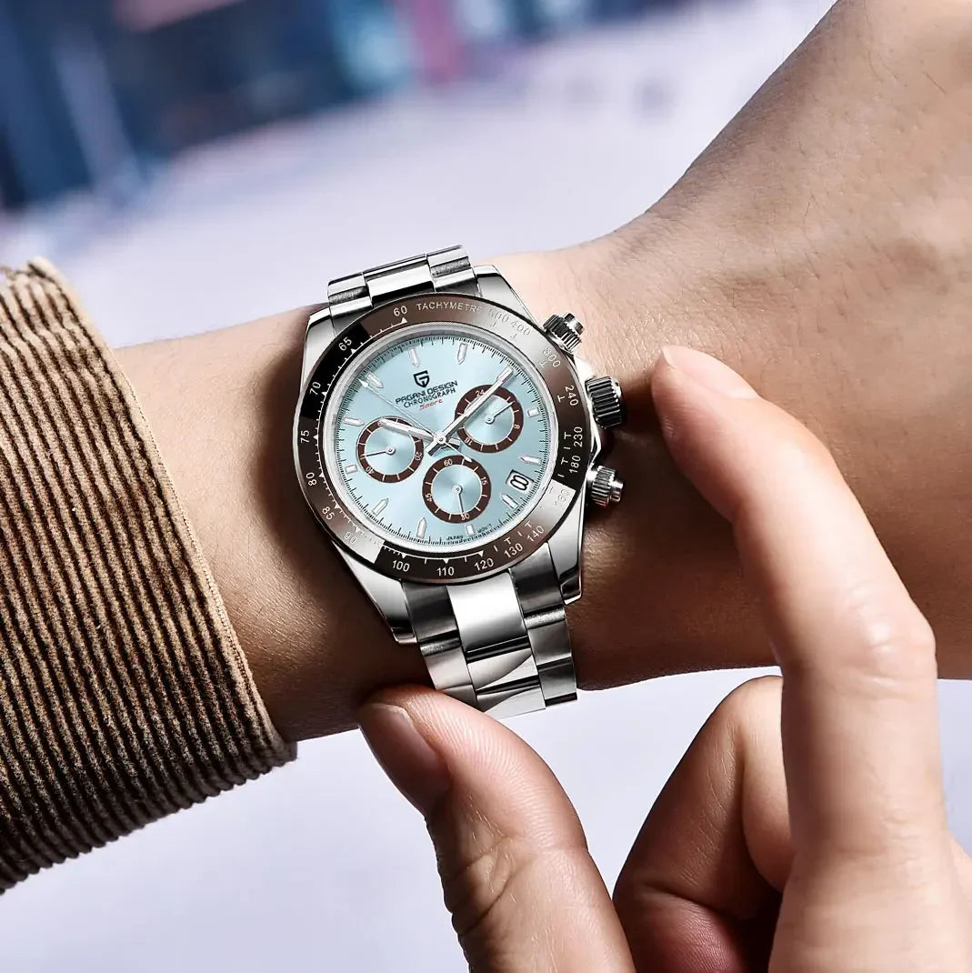 Silver watch with a light blue face on a wrist, blurred background