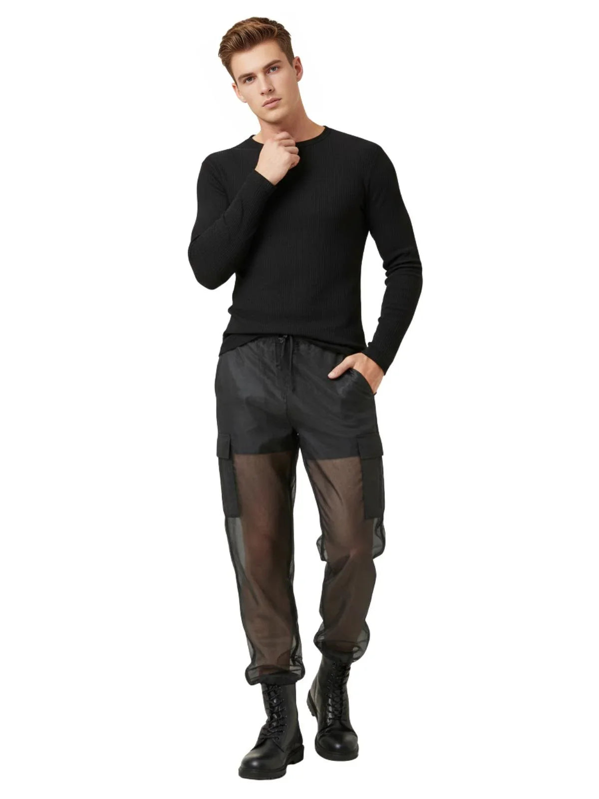 Man wearing a black long-sleeve shirt and black pants with sheer panels on a white background