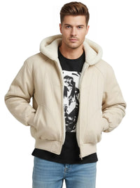Thumbnail for Man wearing a khaki hooded canvas short jacket over a graphic t-shirt on a white background