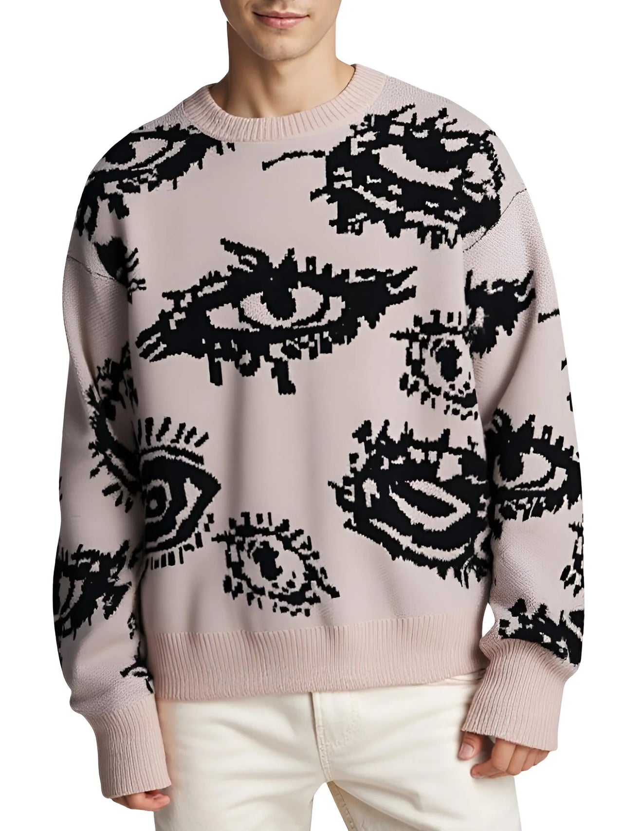 Person wearing a khaki sweater with black eye pattern on a light background