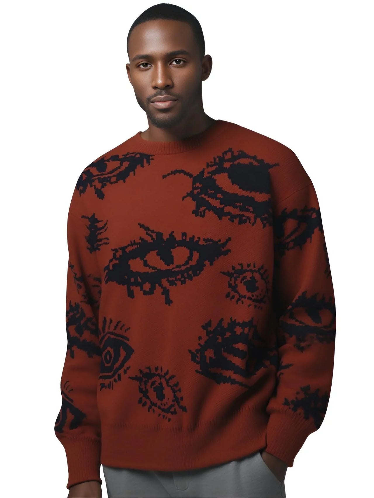 Man wearing a rust red sweater with black eye patterns on a white background