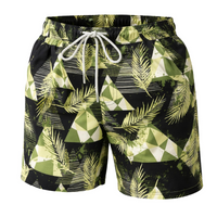 Thumbnail for Green and black patterned swim shorts with a drawstring on a white background