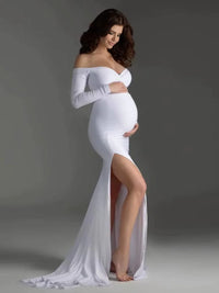 Thumbnail for Pregnant woman in a white off-shoulder gown with a high slit on a gray background