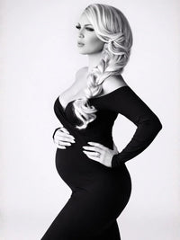 Thumbnail for Woman in a black dress with styled hair against a white background