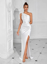 Thumbnail for Woman wearing a white one-shoulder draped maxi dress with a high slit in a stylish interior setting.
