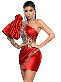Thumbnail for Woman wearing a red mini dress with a large bow on a white background
