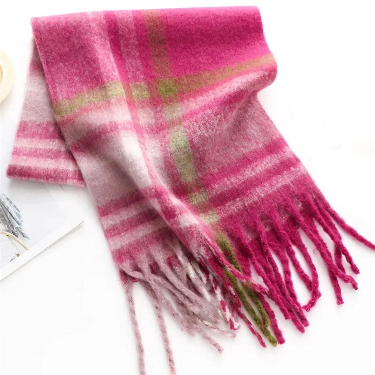 Pink and green plaid scarf with fringes on a white background