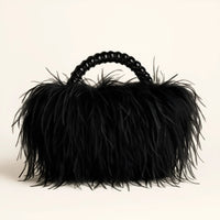 Thumbnail for Black ostrich feather handbag with a textured handle on a beige background