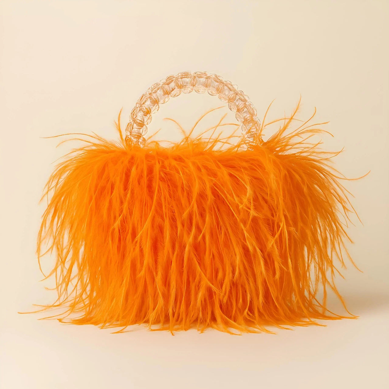 Orange ostrich feather handbag with a decorative handle on a beige background