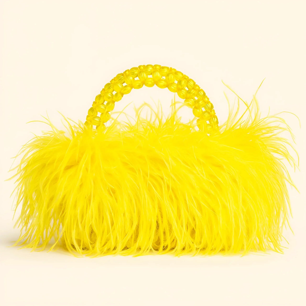 Yellow ostrich feather handbag on a beige background