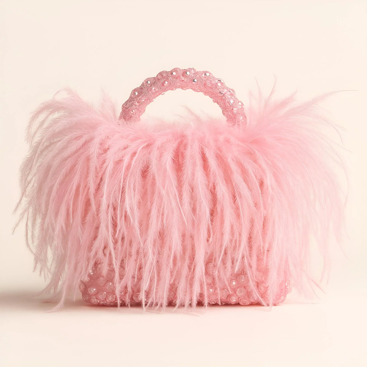 Pink ostrich feather handbag with decorative handle on a light background
