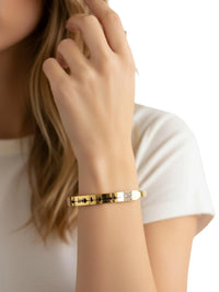 Thumbnail for Gold voice bracelet with QR code on a person's wrist with a white background
