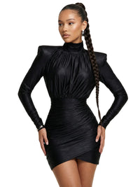 Thumbnail for Woman wearing a black long sleeved mini dress with high collar on a white background. 