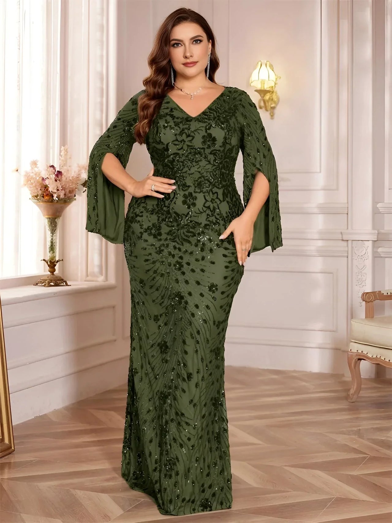 Woman wearing an olive green plus size evening dress in an elegant room.