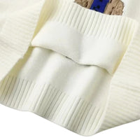 Thumbnail for Close-up of a white knit sweater with a textured pattern.