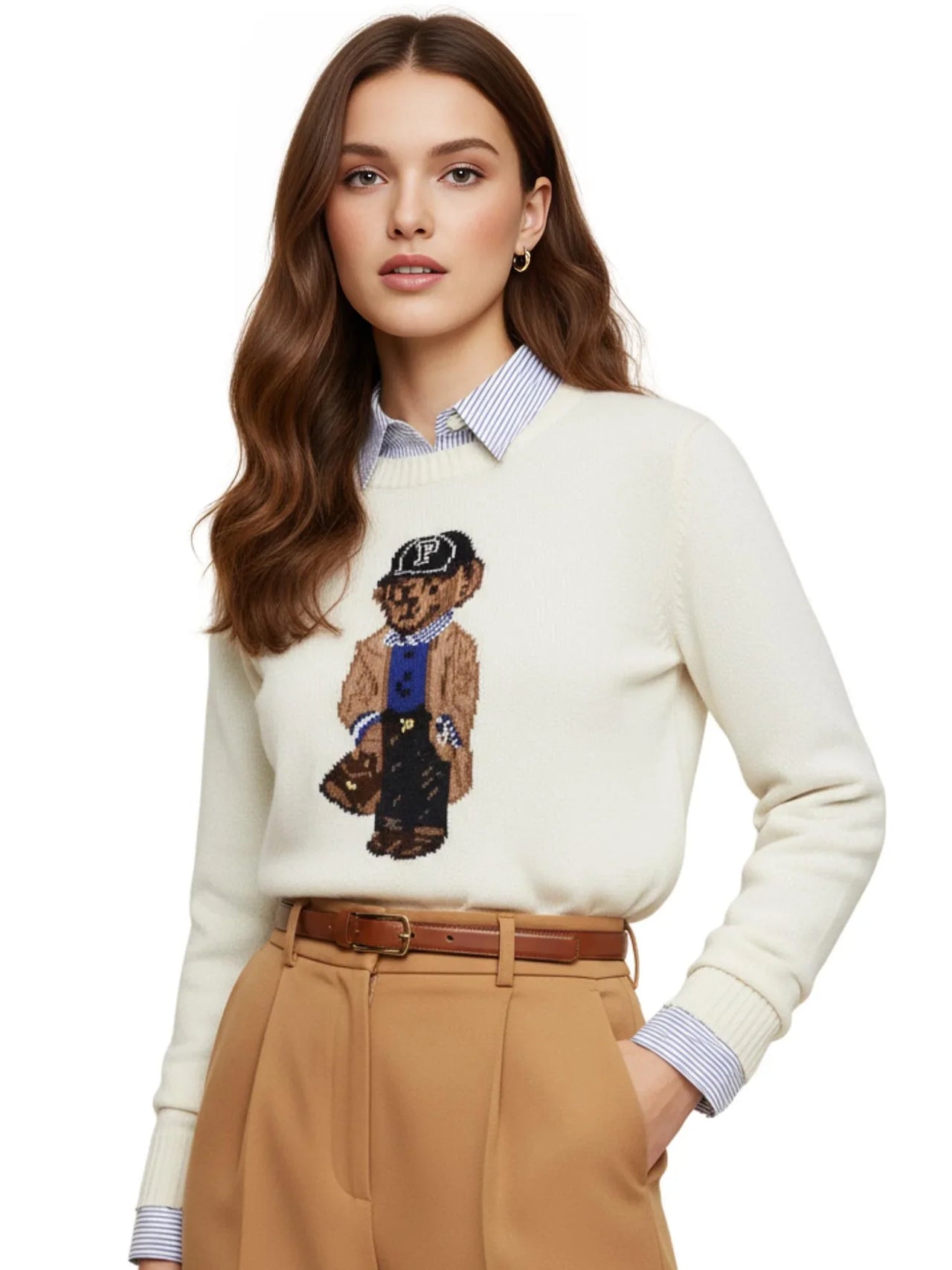 Woman wearing a white pullover sweater with a teddy bear design, beige pants, and a brown belt.