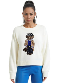 Thumbnail for Woman wearing a white sweater with a bear graphic, standing against a white background