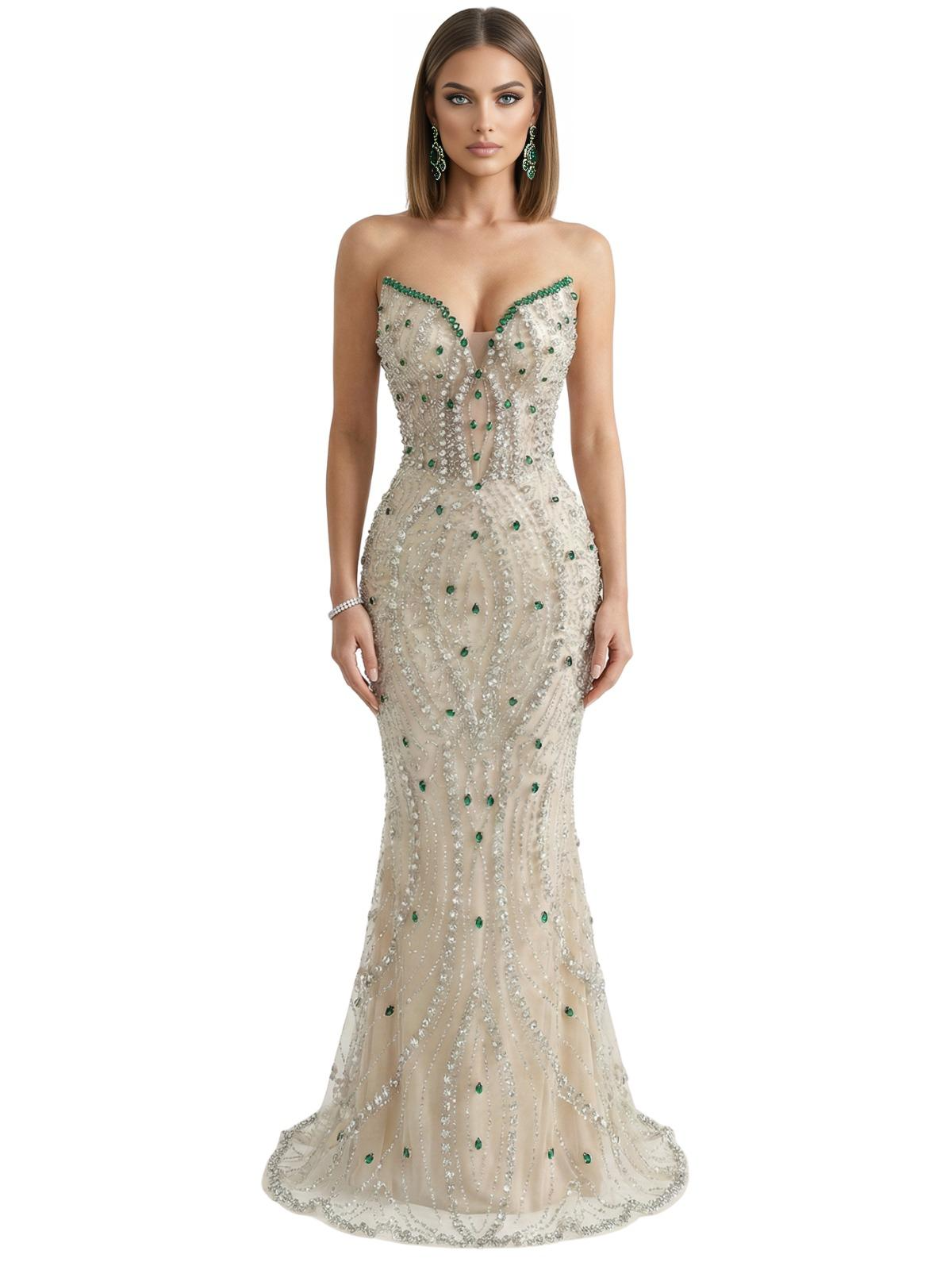 Woman wearing a strapless, beaded mermaid evening gown with green gem stones on a white background
