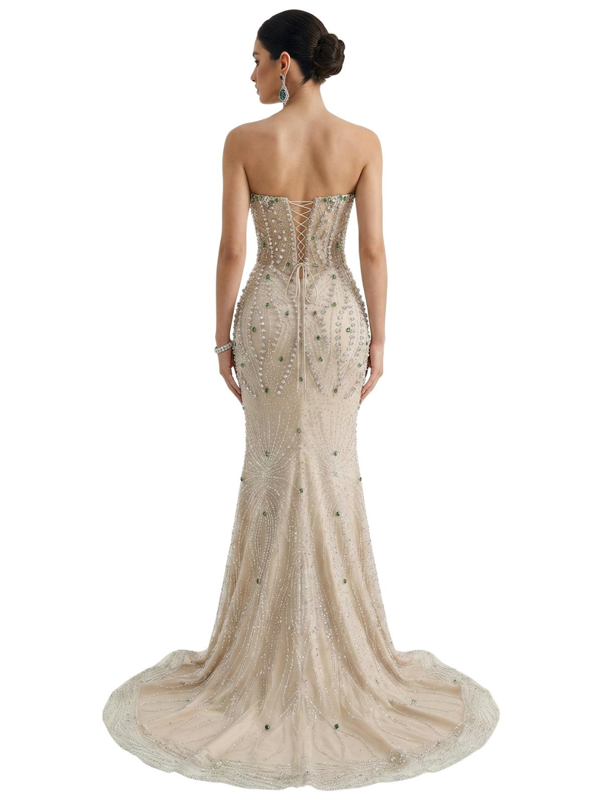 Woman wearing a strapless, beaded mermaid evening gown on a white background