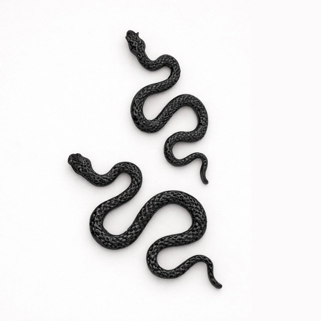 Black snake earrings on a white background