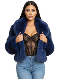 Thumbnail for Woman wearing a blue fur coat over a black lace top and blue jeans on a white background