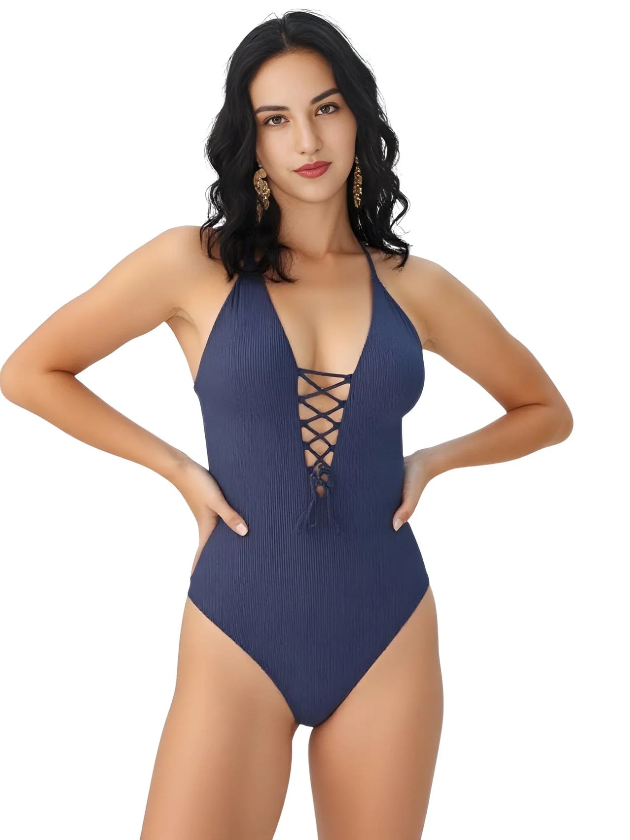 Woman wearing a navy blue swimsuit with lace-up front on a white background