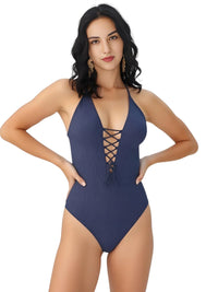 Thumbnail for Woman wearing a navy blue swimsuit with lace-up front on a white background