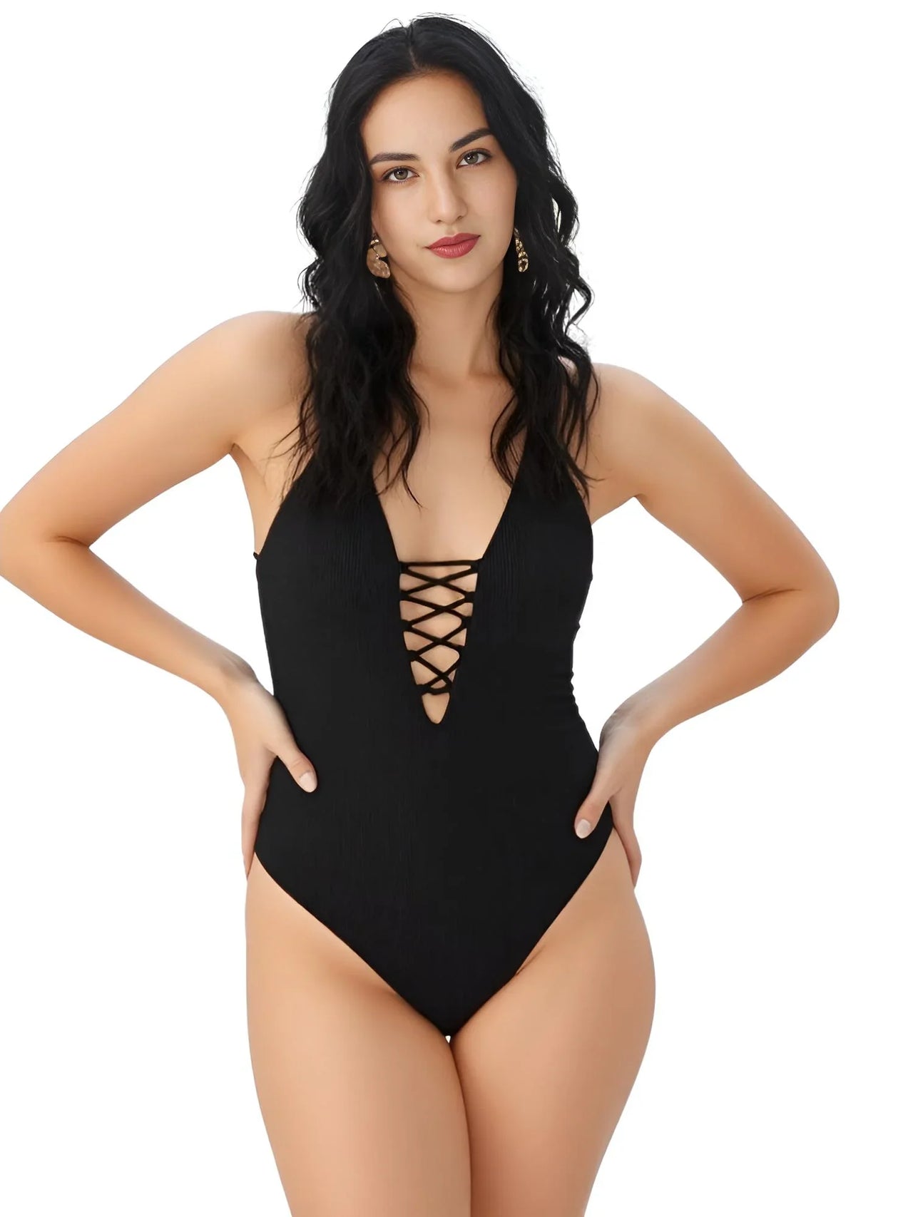 Woman wearing a black swimsuit with a plunging neckline and lace-up details on a white background