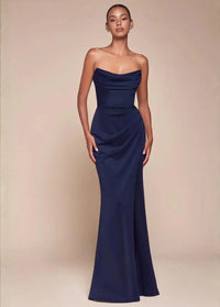Thumbnail for Woman wearing a strapless navy evening gown with a high split against a beige background