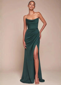 Thumbnail for Woman wearing a green strapless evening gown with a high split on a beige background