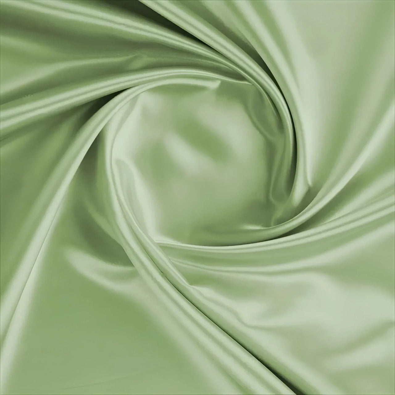 Close-up of green satin fabric with folds