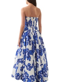 Thumbnail for Woman wearing a blue floral strapless long bubble dress with a high slit on a white background